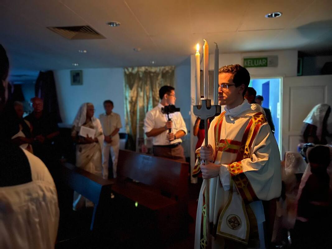 Priest in procession during the Easter Midnight Mass